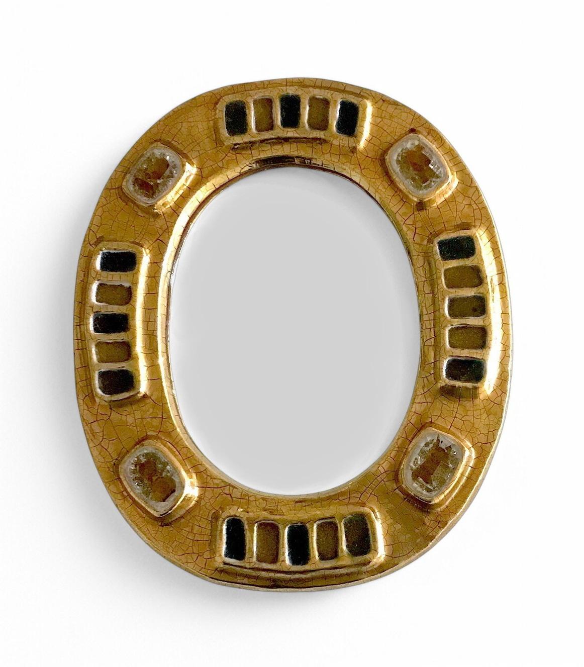 The Mérida Mirror, created circa 1965 by French artist Mithé Espelt (1923-2020), perfectly embodies her unique approach to decorative objects: where refined ornament meets functional design. Made of polychrome and crackled gold with glazed ceramic