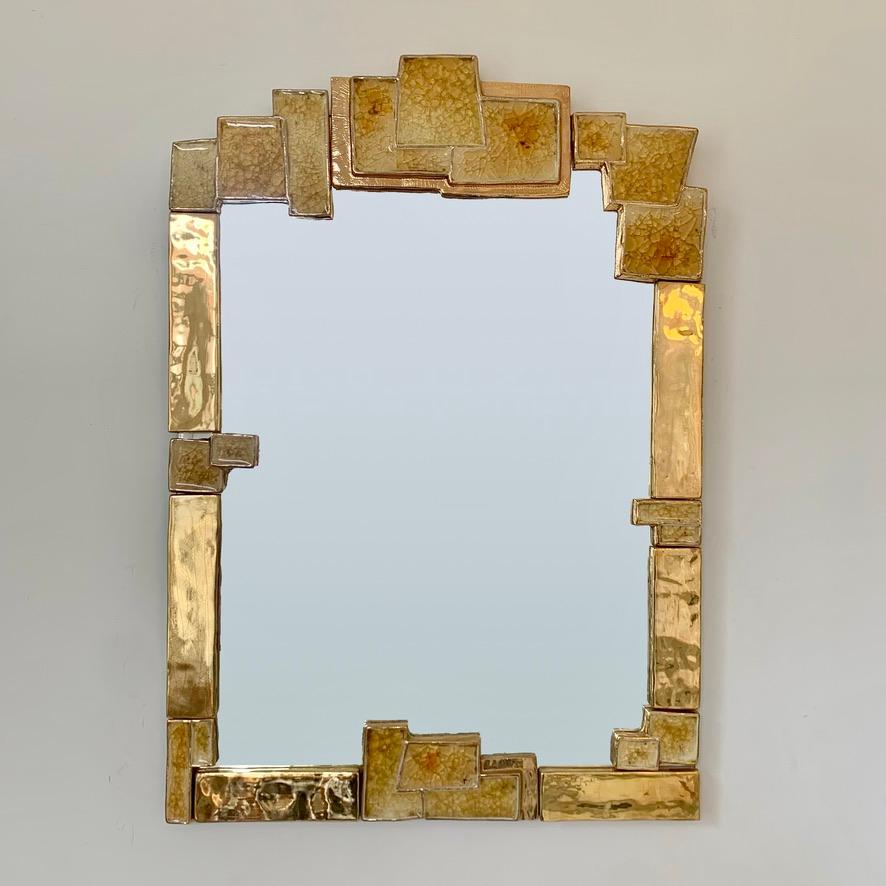 Very beautiful large gold ceramic mirror designed by Marion De Crécy, daughter of Mithe Espelt, and produced in his atelier circa 1990, France.
Golden enameled ceramic, yellow shades enamels, mirror glass.
Original design in good condition.
Rare