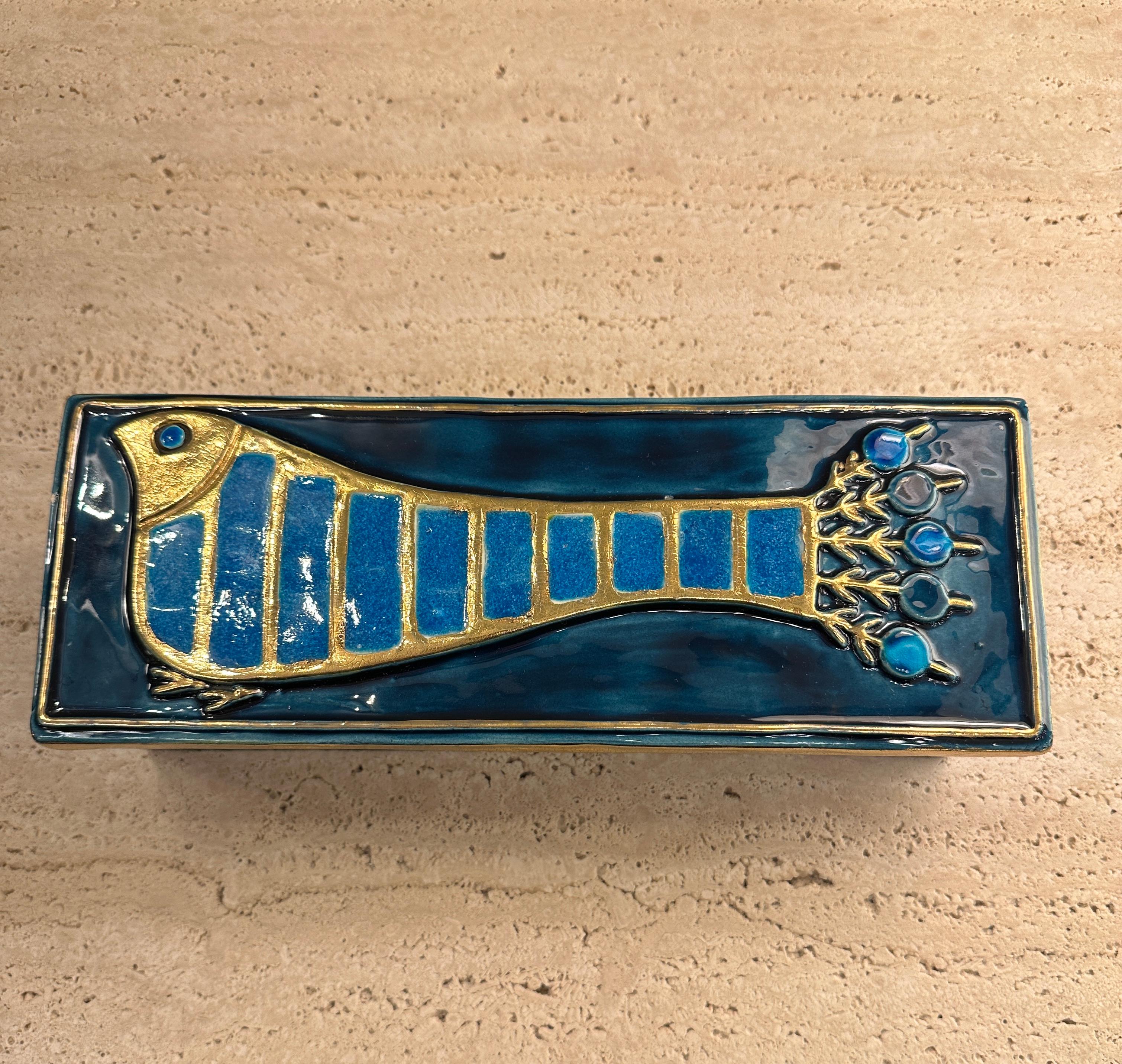 Rectangular wood box topped with an enameled ceramic lid representing a peacock