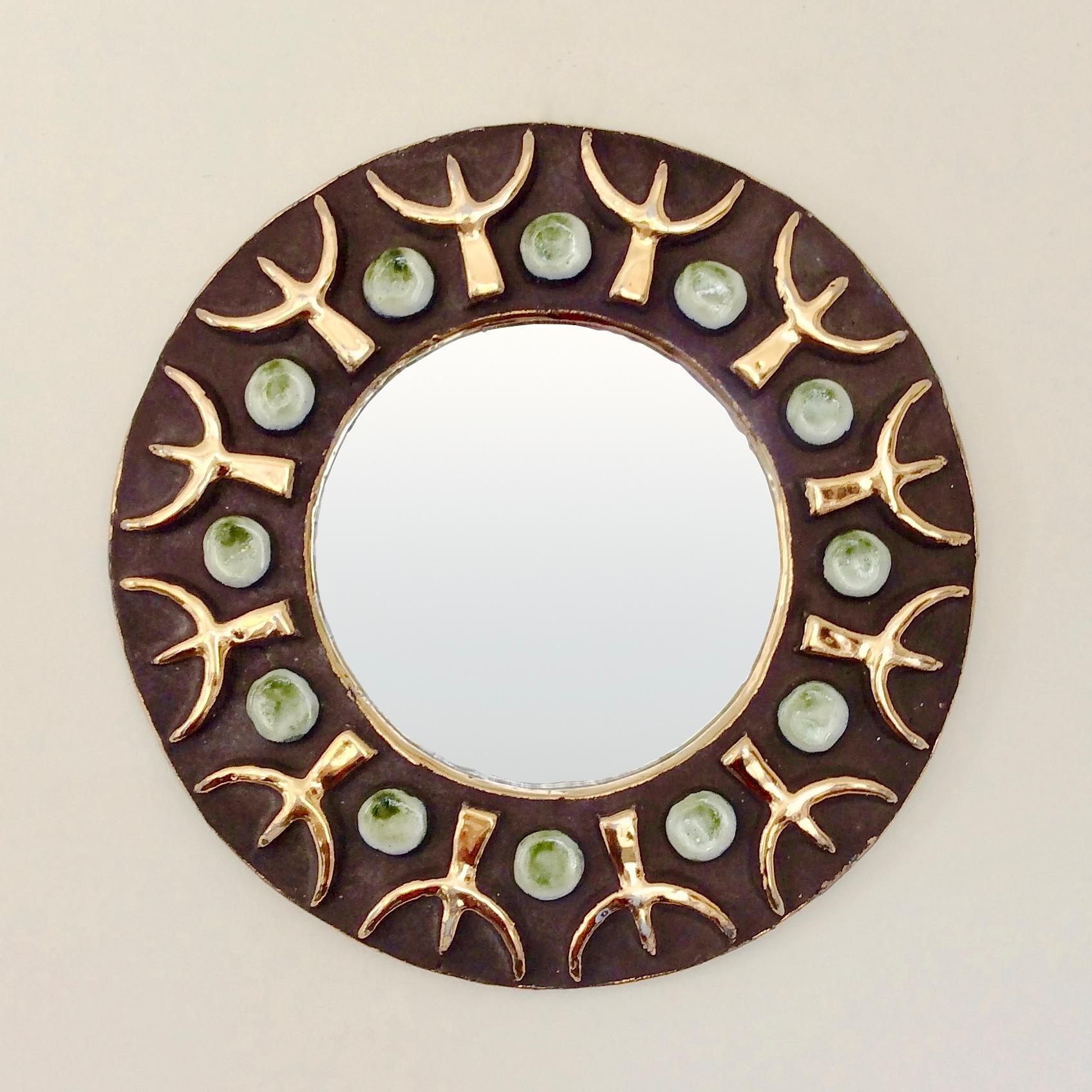 Beautiful Mithe Espelt round wall mirror, circa 1970, France.
Black ceramic with gold, white and green enameled decor.
Dimensions: 23 cm diameter, 2 cm D.
Original vintage item in good condition.
All purchases are covered by our Buyer Protection