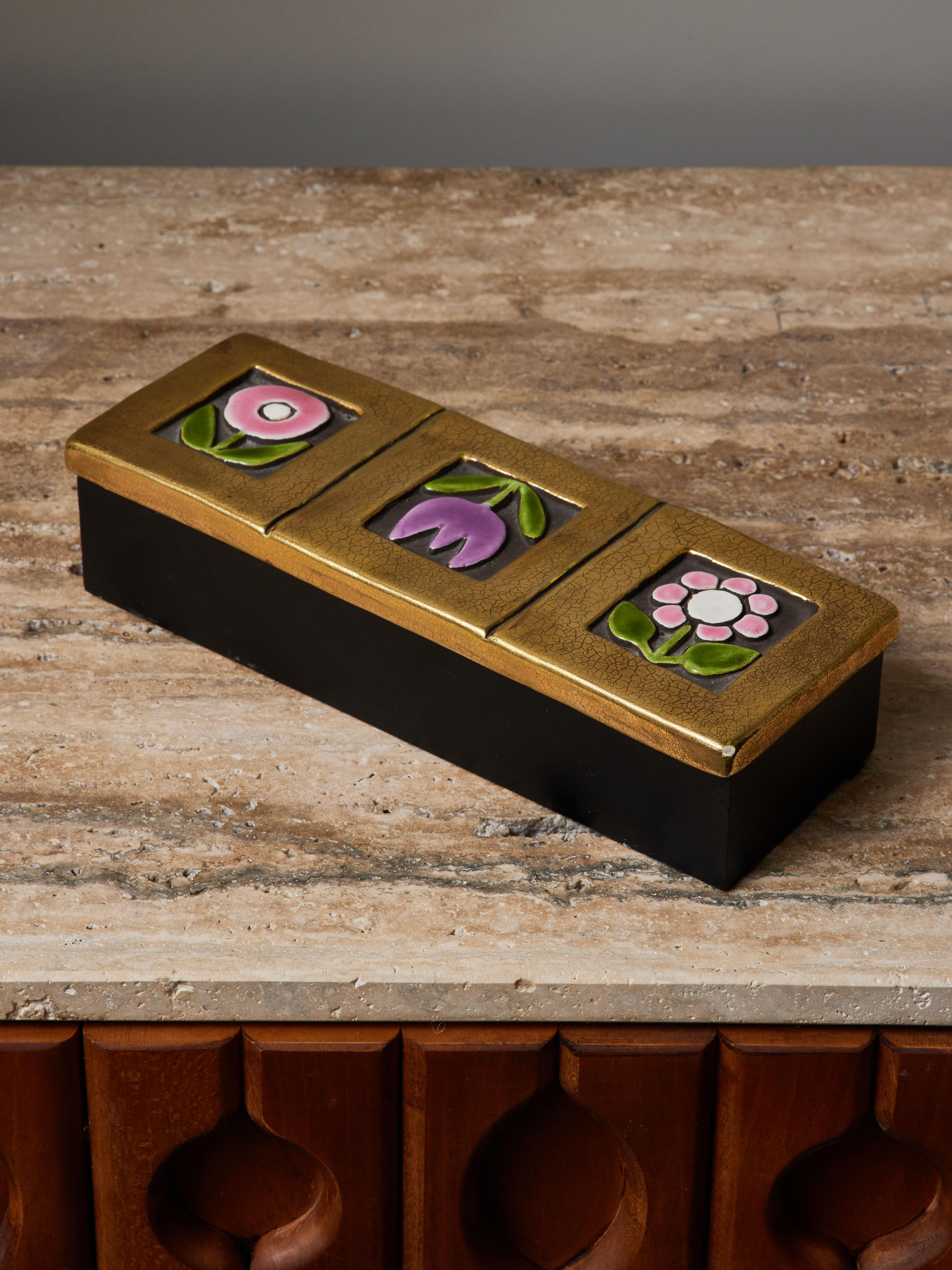 Rectangular wood box with decorated lid. Three gold squares each framing a single flower, all in various coloured glazed ceramic.


Marie Thérèse Espelt, aka. Mithé Espelt (1923-2020)

Born in the town of Lunel, near Montpelier; Mithé Espelt
