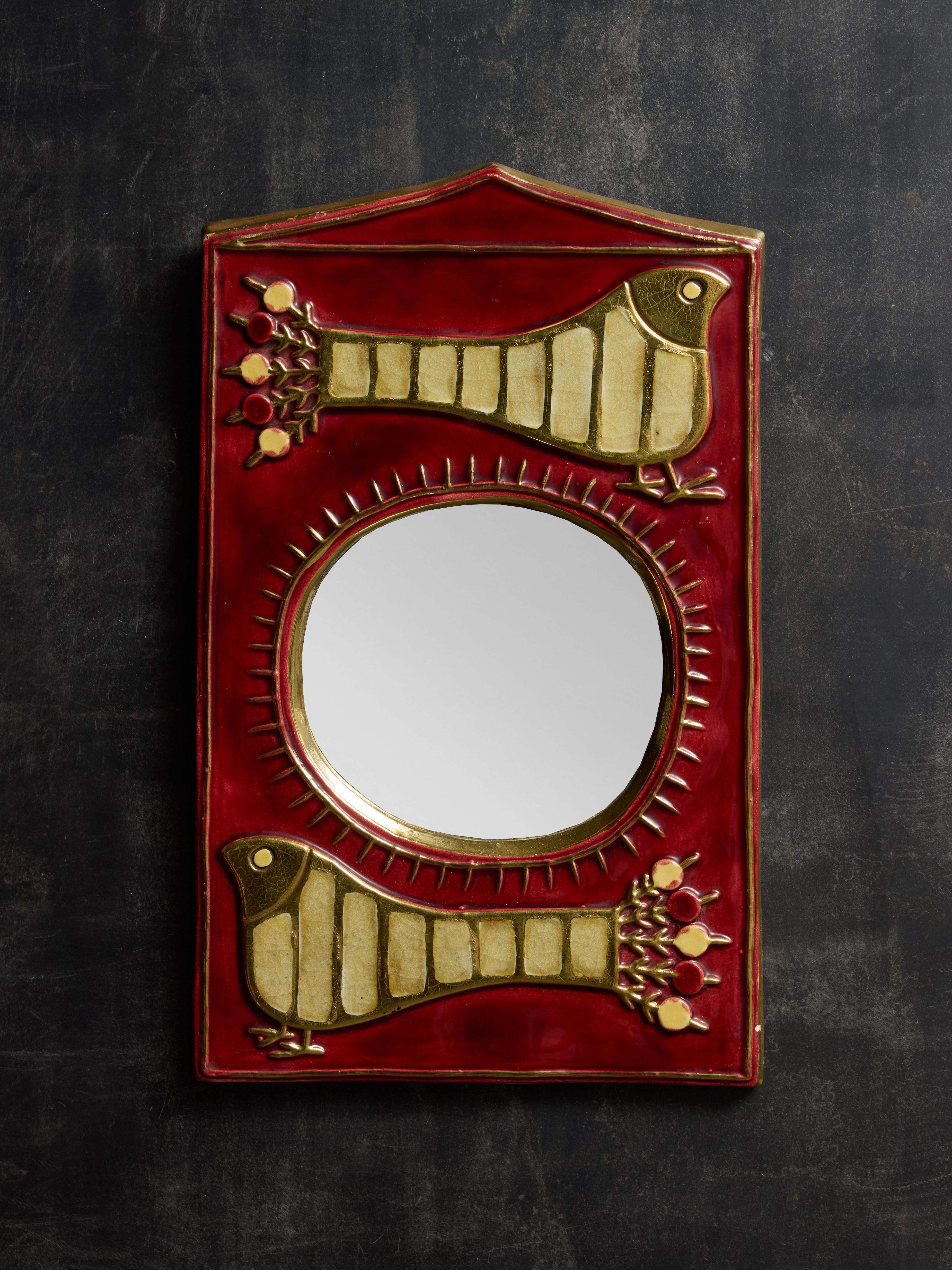 Wall piece made by Mithé Espelt, it is made of a round mirror incased in ceramic with peacock decors and beautiful red and gold glaze.

Marie Thérèse Espelt, aka. Mithé Espelt (1923-2020)

Born in the town of Lunel, near Montpelier; Mithé Espelt