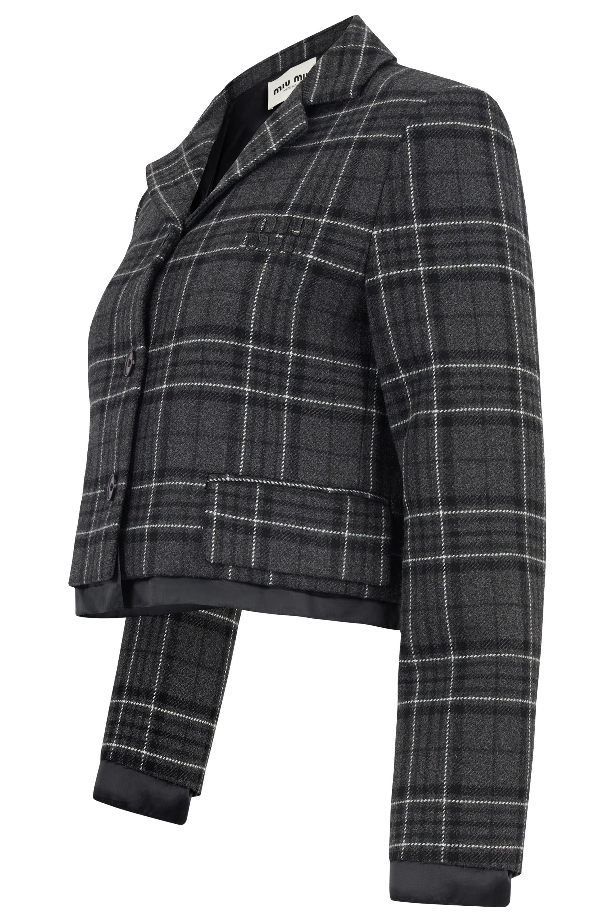 Miu Miu checked wool jacket. Crafted from a soft wool blend, this tailored piece features a classic grey check pattern with subtle white accents. Cropped fit with lining poking out, two front fake flap pockets. Fastens with buttons front closure.