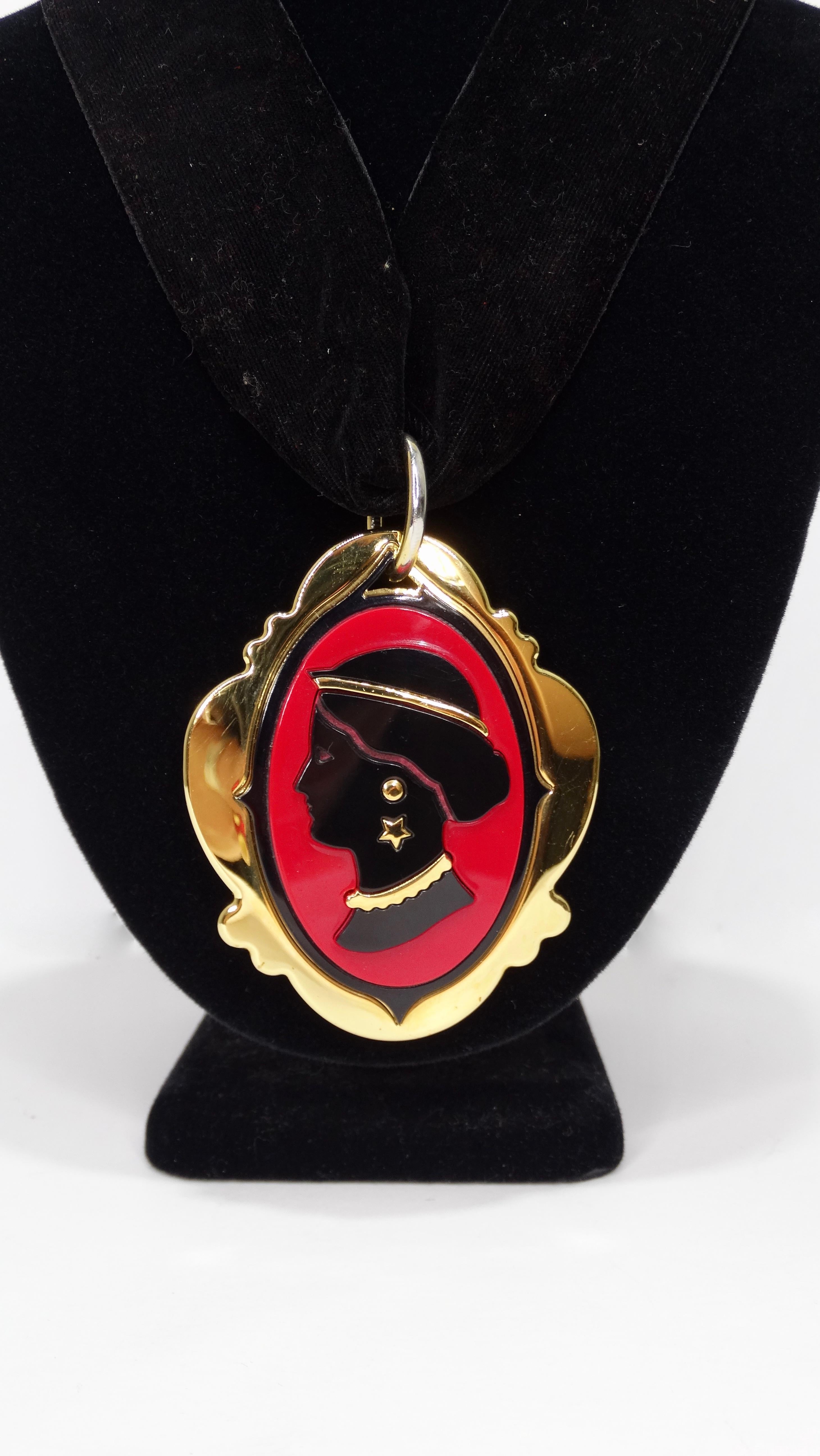 Elevate your look with this amazing Miu Miu cameo necklace! Circa 2012 from their S/S collection, this love token inspired necklace features a thick black velvet ribbon with a large black and red plexi glass cameo pendant. Includes gone toned