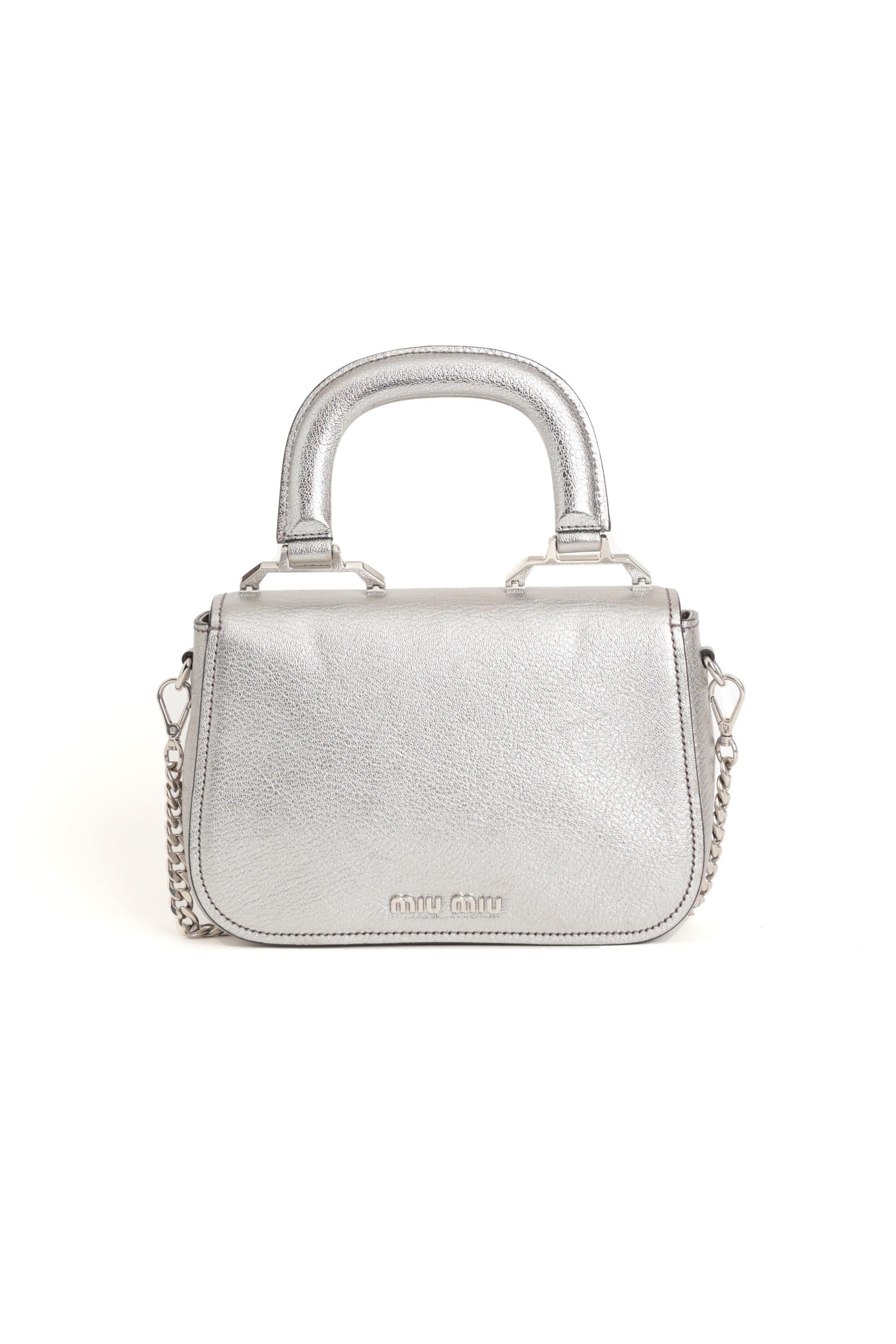 We are excited to present this lovely Miu Miu 2018 Madras silver Handbag with a removables silver  crossbody chain. Features silver hardware flap and lock popper closure and inside zip pocket. Pre-loved, in excellent condition. Authenticity