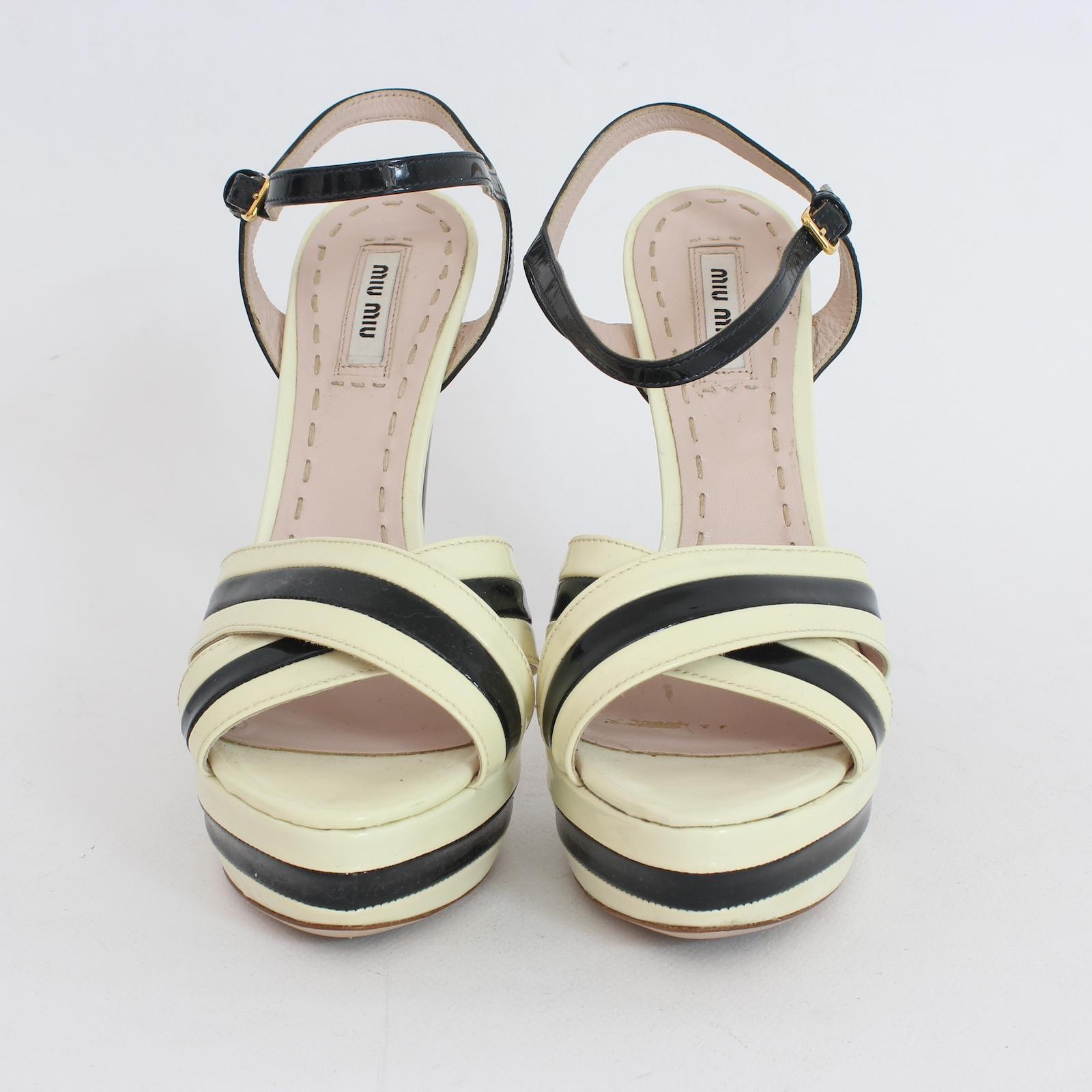 Step into style with Miu Miu's sleek 2000s patent heels. The beige and black woven design, ankle strap and plateau provide a unique touch while offering comfort and stability. Up your fashion game with these timeless pieces.

Size: 38 It 6.5 Us 5 Uk