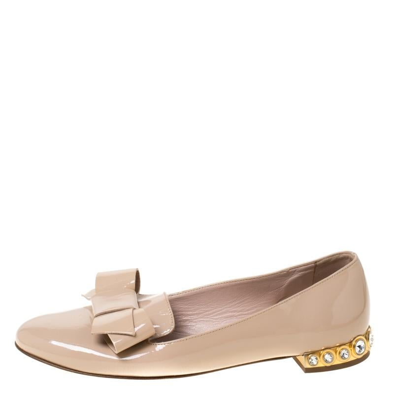 These ballet flats from Miu Miu will not only make you shine but will also fetch you a lot of admiring glances. The beige loafers are crafted from patent leather and feature round toes, bow details and embellished heels that look amazing.

