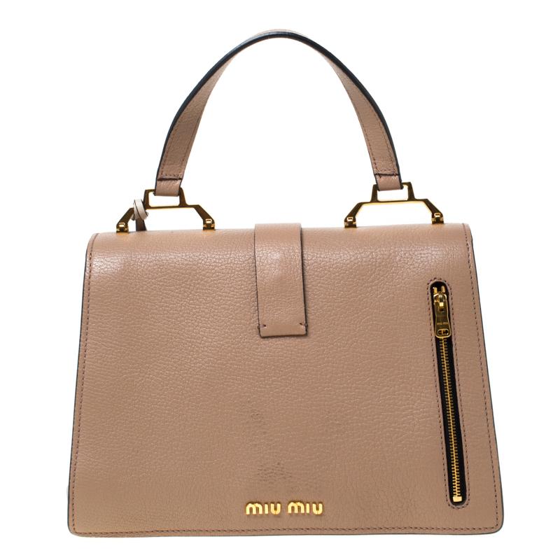 Miu Miu ‘Madras’ bag takes its name from specialist leather originating in Southeast India. Crafted from two-toned leather and accented with gold-tone hardware, it features a flat top handle, an optional shoulder strap and gusseted sides. The suede
