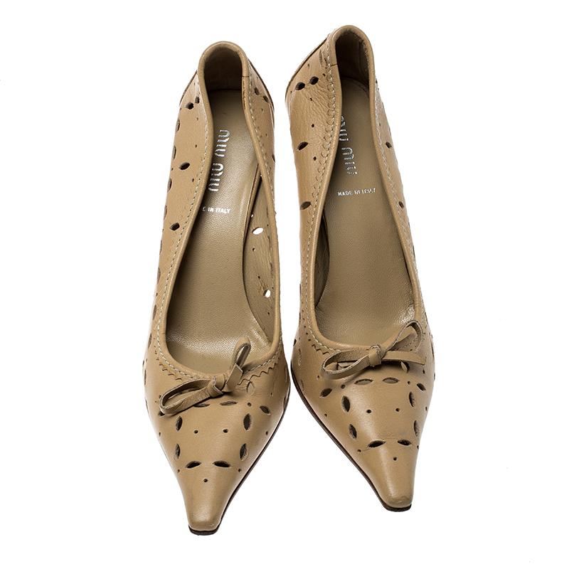 This leather-made pair adds a feminine touch to your outfit. Flaunt this subtle yet classy beige pair at the next big gathering. Look radiant and lively in these pretty pumps by Miu Miu.

Includes: Original Dustbag

