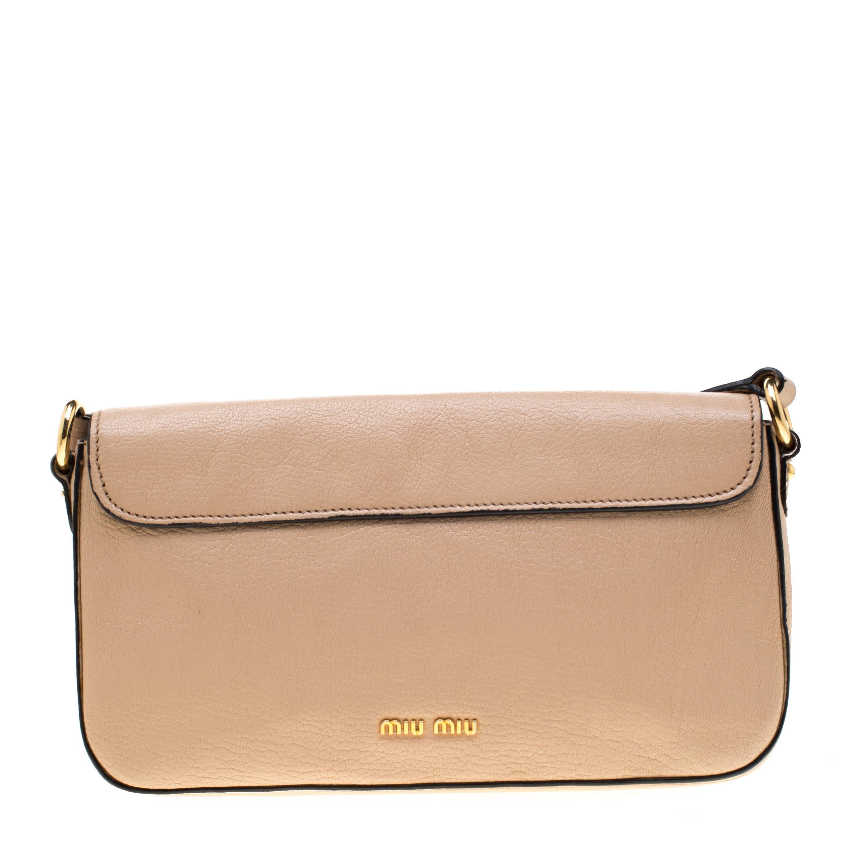 This beautifully crafted leather crossbody bag will surely fetch a lot of compliments for its uber-classy appeal and rich look. It is lined with fabric that allows you to keep your essentials intact. Flaunt this beige Miu Miu bag and let it enhance