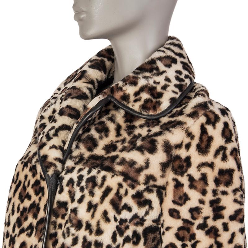 100% authentic Miu Miu leopar-print coat in brown, beige, and black dyed sheep fur and leather. With rounded notch collar, leather trims, straight yoke on the front and back, and two slit pockets on the front sides. CLoses with concealed snaps on