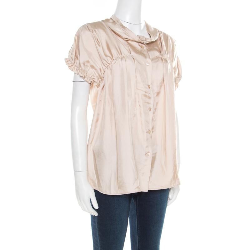 Isn't this blouse from Miu Miu simply amazing! The beige satin creation features a ruched bodice detailing and comes with front button fastenings and short sleeves. Pair it with smart denims and ballet flats for your fashionable outings.

Includes: