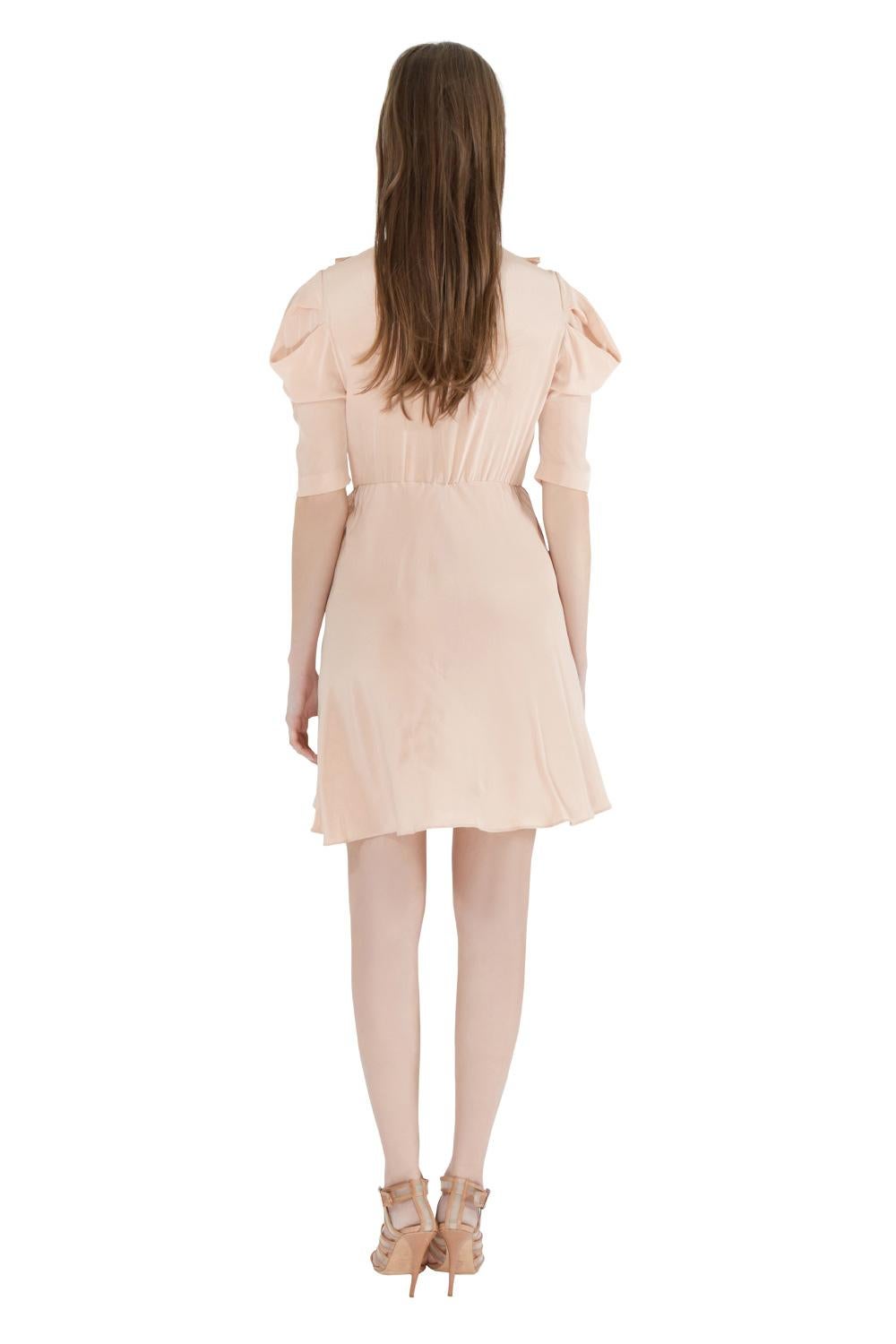 Super feminine and pretty, this Miu Miu dress will definitely fetch you lots of compliments. The lovely ruffle trims, lace inserts at the front and subtly pleated sleeves make this dress a woman's dream. Team it with strappy sandals for your dinner