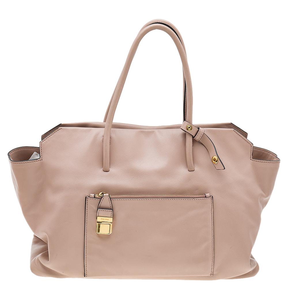 Swap your current bag with this pre-owned Miu Miu tote. Crafted in Vitello soft leather, this spacious bag can store all that you need in its interior. The tote has a front pocket, dual handles, and a detachable strap.

Includes: Original Dustbag,