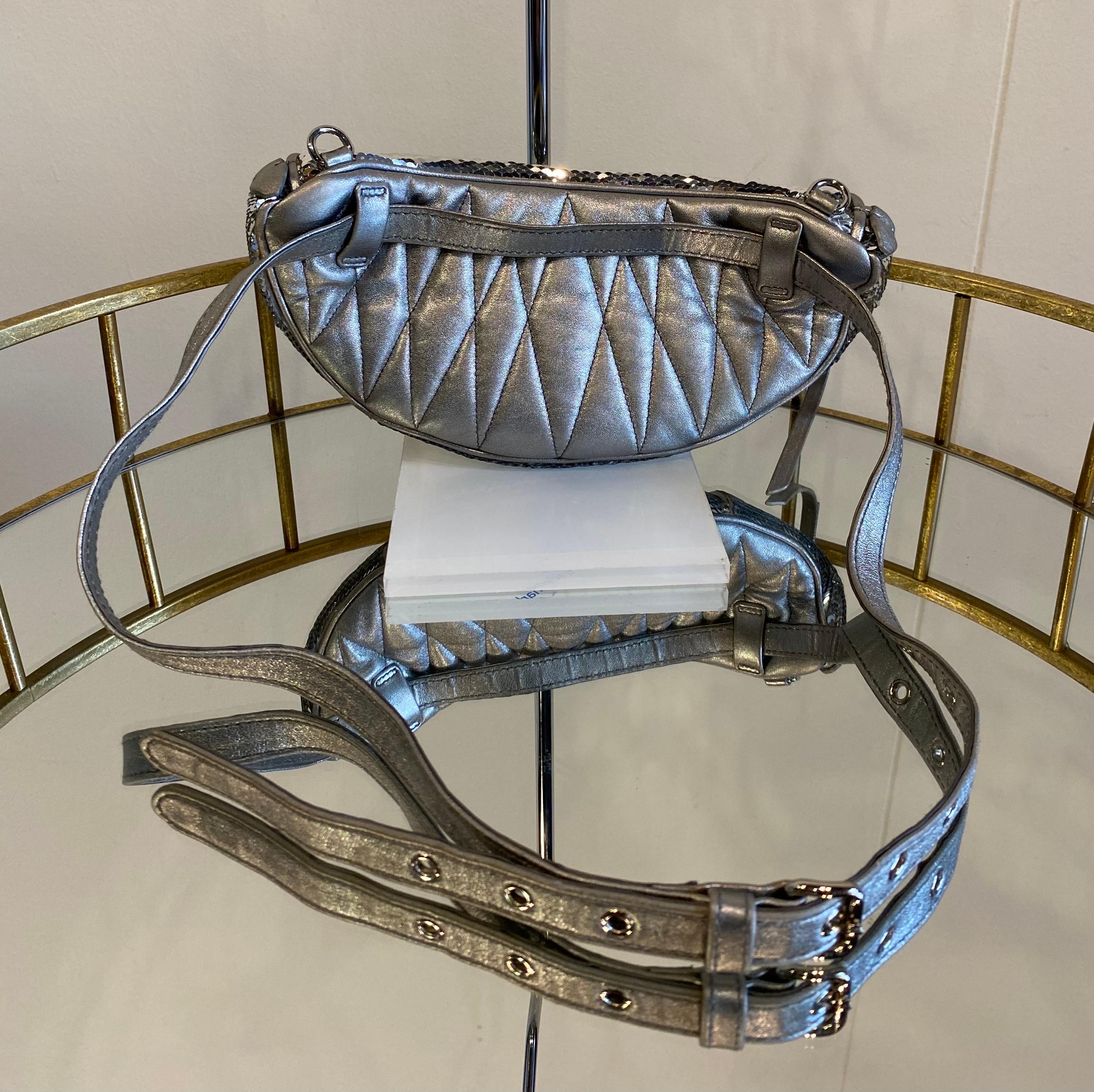 Miu Miu belt bag in silver sequins with zip closure. The pouch is equipped with a strap that can be slipped on and off as desired. The back is in silver fabric. The pouch is equipped with the original dustbag, is in good condition, with only very