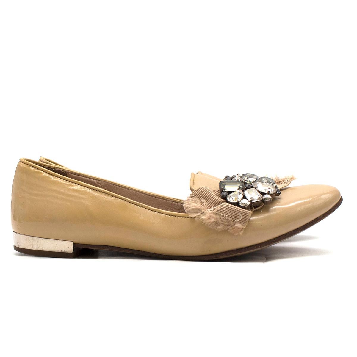 Miu Miu Biege Patent Leather Crystal Embroidered Loafers 

-Beige, patent loafers 
-Crystal embroidery 
-Beige ribbon detail 
-Slip-on style
-Silver slight heel
-Light pink leather insole

Please note, these items are pre-owned and may show some