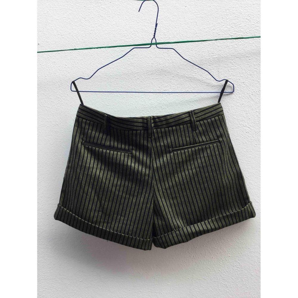 Miu Miu Black and Yellow Striped Pattern Wool Mini Skirt in Khaki

Miu Miu mini shorts. 
 Black and yellow striped pattern. 
 Two false pockets at the back. Introduce the belt loops. 
 Composition: 98% virgin wool, 2% other materials. 
 Excellent