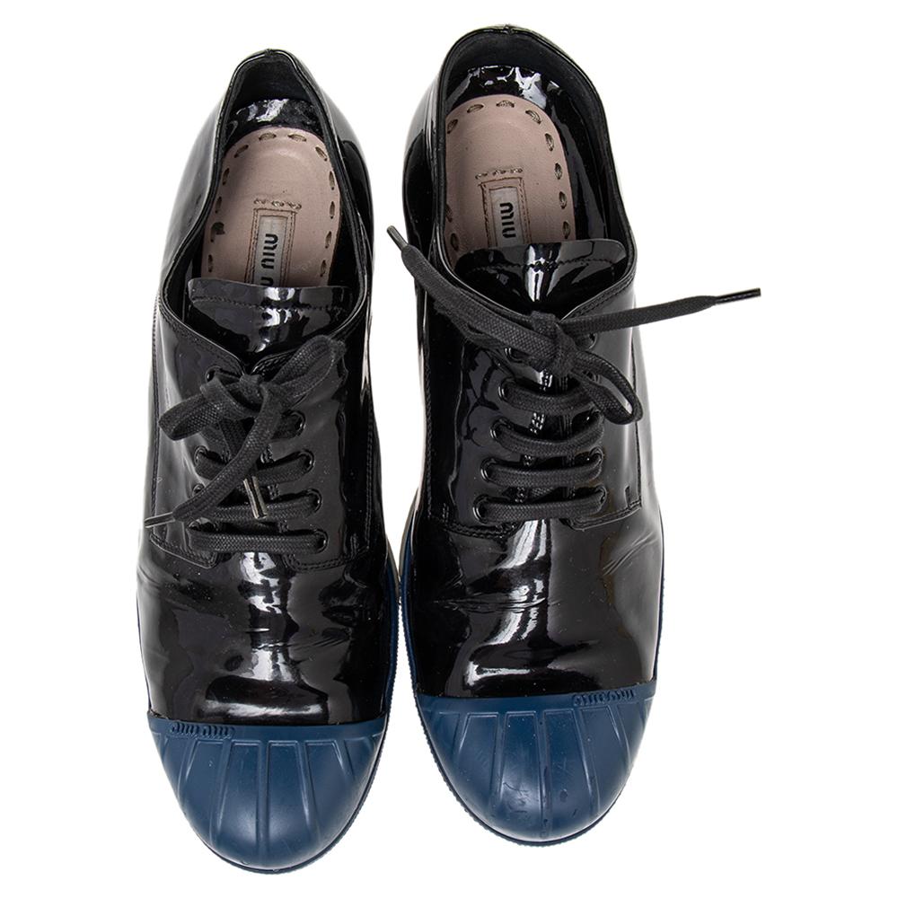Who knew sneakers could look so glamorous! These black & blue ones from Miu Miu come crafted from glossy patent leather & rubber and styled with cap toes. They exhibit lace-ups on the vamps and are equipped with comfortable leather-lined insoles.