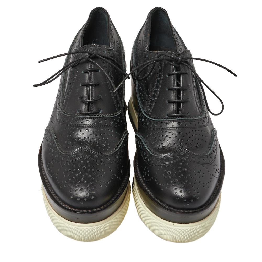 Made of leather with brogue detailing, these oxford sneakers from Miu Miu come with rounded toes. It features white platform heels and a rubber sole on the outside. To balance the classy looks, it comes with lace-up closure on the top.

