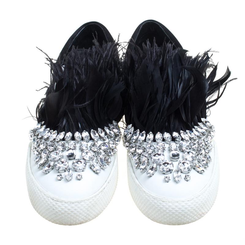 The words 'edgy' and 'ultra-modern' can be readily attributed to this pair of sneakers from Miu Miu. Crafted from satin, they feature a posh exterior with crystals and Marabou feathers designed on the uppers. Rubber soles and the brand label on the