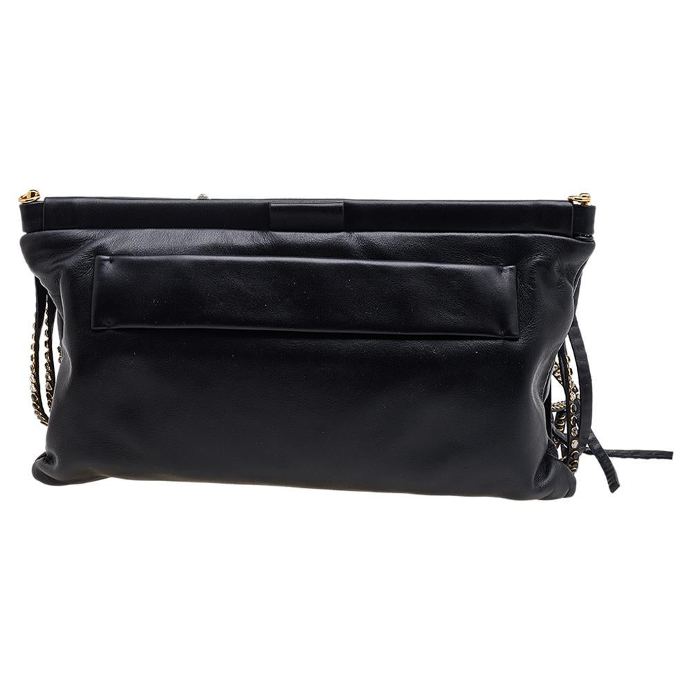 Made in an attractive shape and enhanced with signature details, this clutch from the House of Miu Miu will be your beloved accessory in no time! It is made from black leather, with embellished fringes elevating its beauty. It opens to a satin-lined