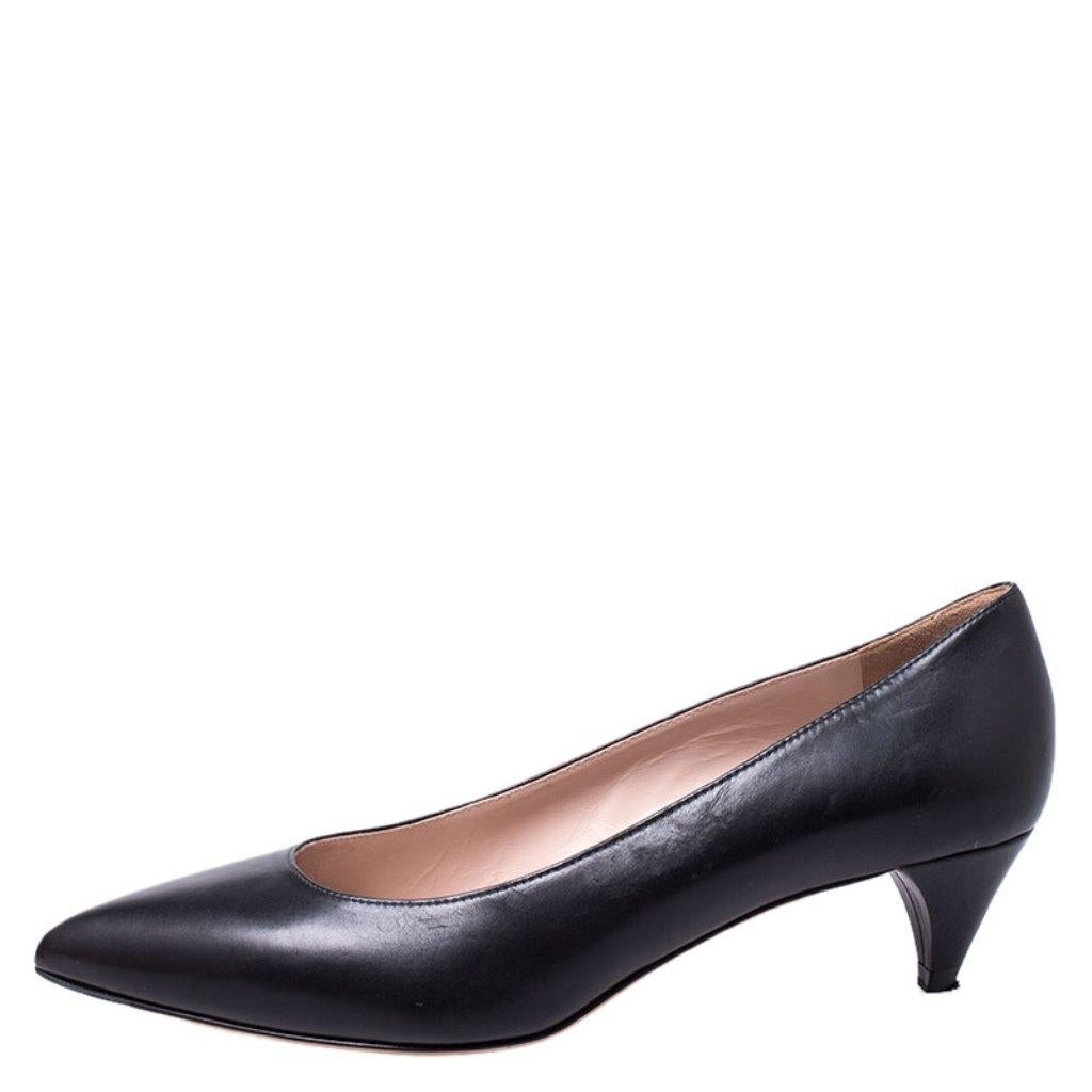 These feminine pumps from the house of Miu Miu are crafted from black leather. They feature pointed toes, leather insoles and kitten heels. Wear them on days when you don't want to wear super high heels.

Includes: Original Dustbag, Original Box,