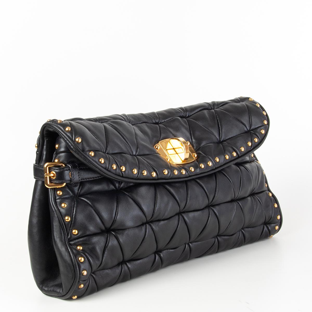 100% authentic Miu Miu matelasse clutch in black lambskin embellished with gold-tone studds and turn-lock. Lined in black satin with one zip pocket agaisnt the back. Has been carried with some scratches on the lock. Overall in excellent condition.
