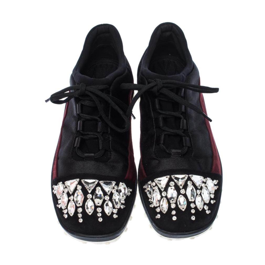 These black sneakers from Miu Miu are so smart, you'll love wearing them for your special outings! They are crafted from fabric and feature maroon suede trims, crystal embellishments on the cap toes, lace-ups on the vamps, comfortable insoles and