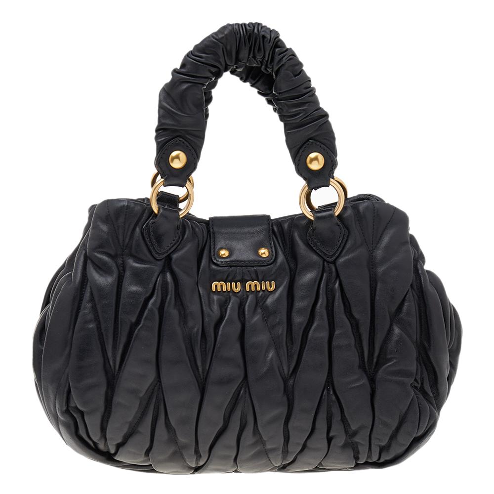 All creations from Miu Miu guarantee high-quality, functionality, and luxury. This Bauletto Aperto bag from Miu Miu is truly beautiful and unique. It is made from black matelassé leather with a gold-toned logo-inscribed lock closure perched on the