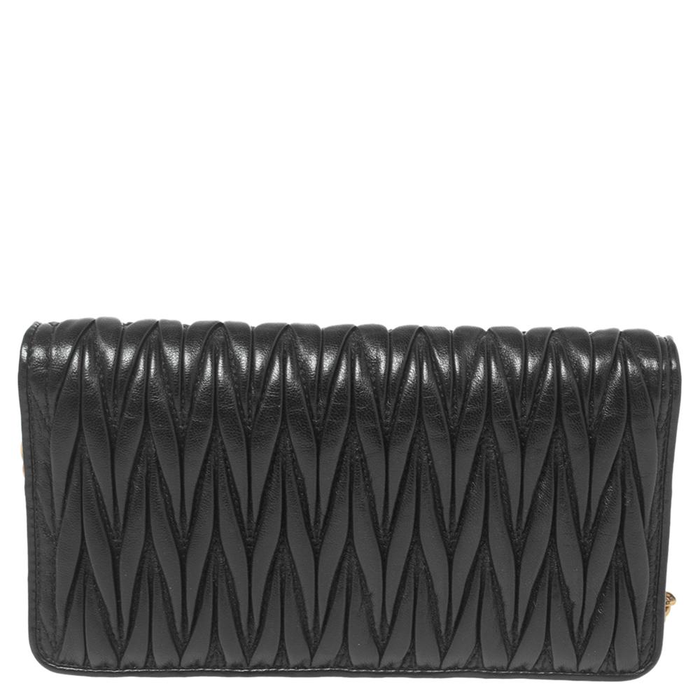 This black clutch from Miu Miu is designed with leather and detailed with the logo on the front. It features a fabric ad leather interior that's sized to hold your little essentials. It is perfect for an evening look.