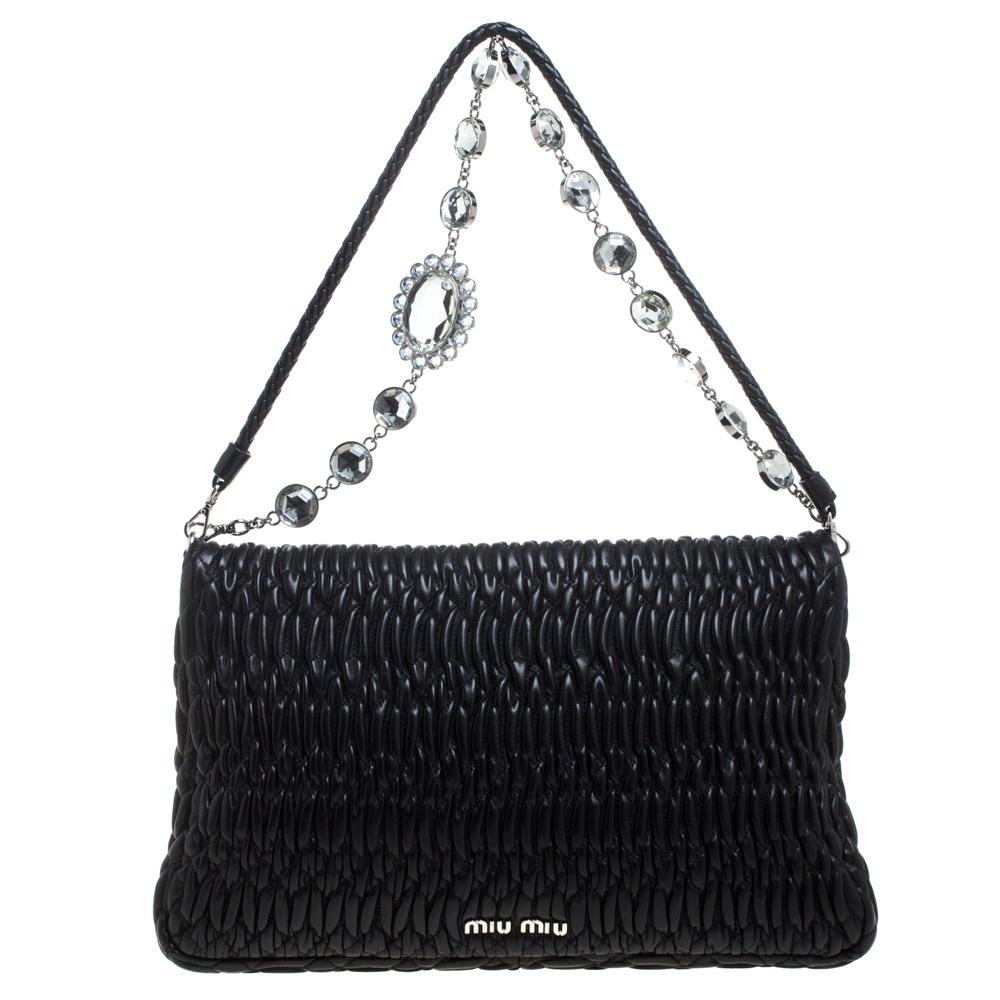 This gorgeous bag by Miu Miu will carry your essentials with ease. Brilliantly designed, this black bag has a flap design and a chain with crystals. Flaunt this pretty-looking Matelasse leather bag for a sophisticated look.

Includes: Authenticity