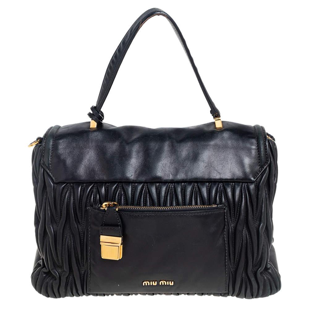 This elegant bag by Miu Miu is a must-have. Crafted from matelassé leather, it is styled with a top handle, front flap with gold-tone closure, and a lined interior. It is finished with protective metal feet.

