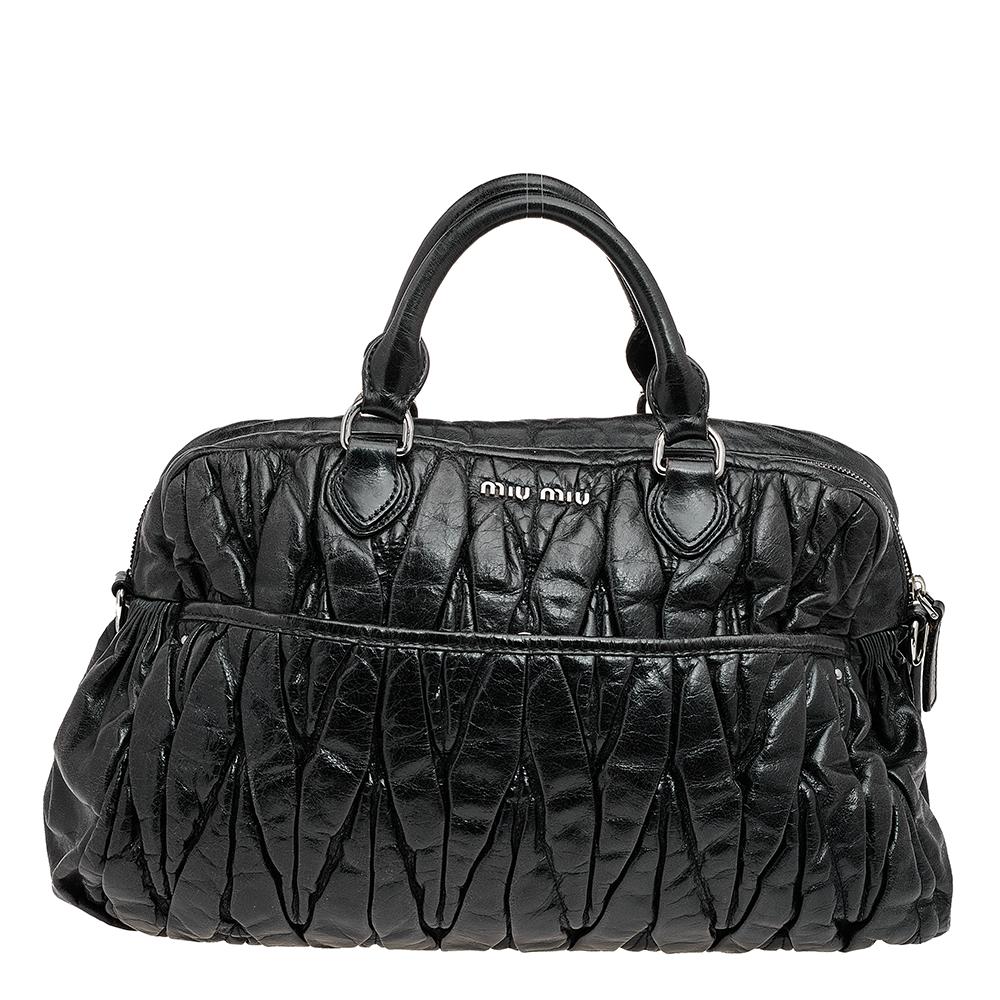 All creations from Miu Miu guarantee high-quality, functionality, and luxury. This tote from the House of Miu Miu is truly beautiful and unique. It is made from black matelassé leather with a silver-toned logo-inscribed lock closure perched on the