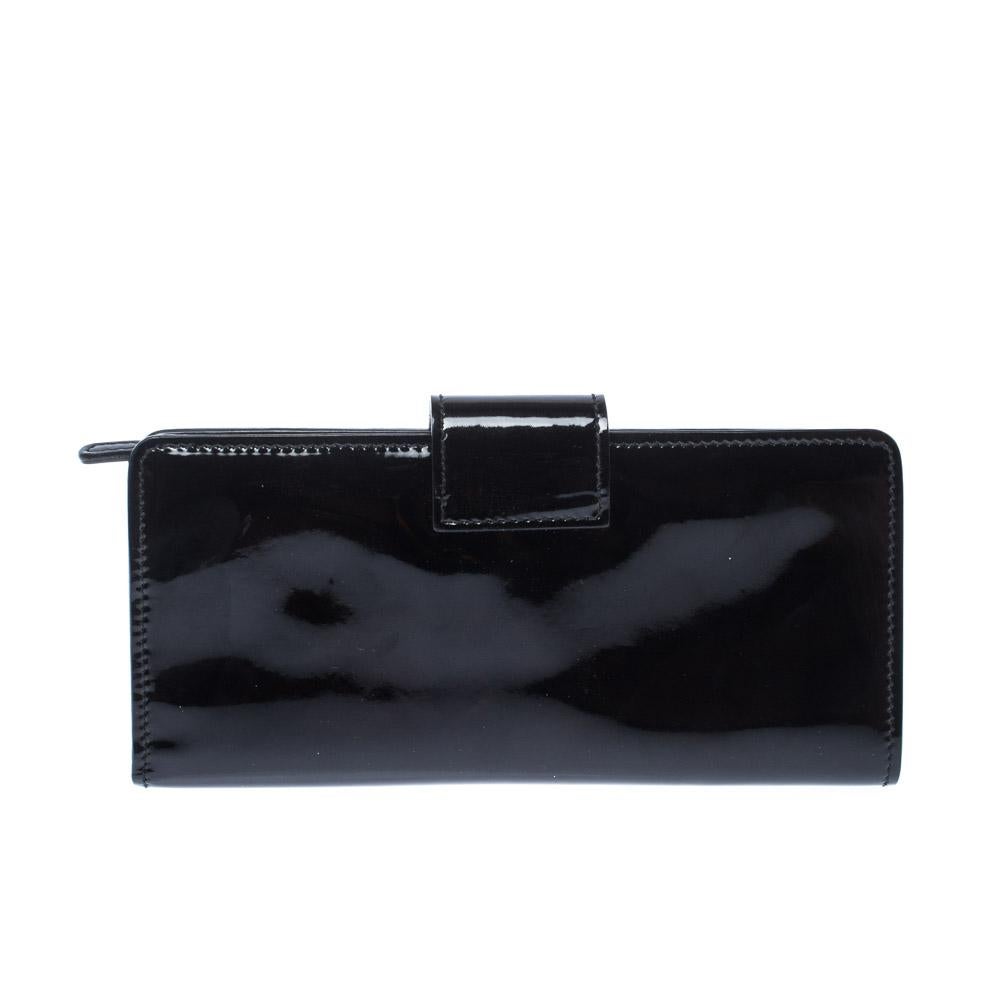 This lovely wallet from Miu Miu will surely delight your impeccable style. It has been crafted from black patent leather and designed with a key lock on the flap. It also brings multiple slots and a zip compartment.

Includes: Original Dustbag,