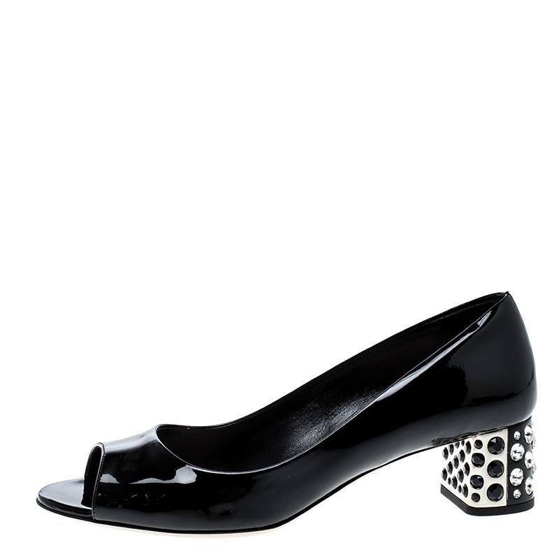 Comfortable to wear and extremely chic and stylish, this stunning pair of Miu Miu open toe pumps is perfect for the day time. Constructed in black patent leather, this beautifully chic pair of shoe features medium sized block heel which is further