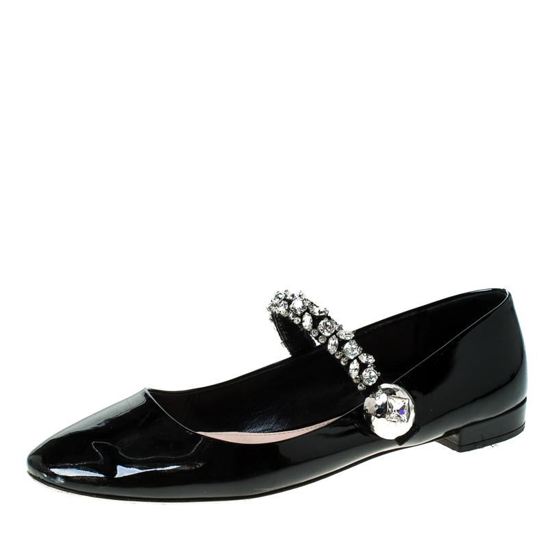 Keep it comfortable and chic with these patent leather flats. They are designed in a Mary-Jane silhouette with pretty crystal embellishments. These flats from Miu Miu will make your feet look pretty and fashionable. Step out in style and confidence