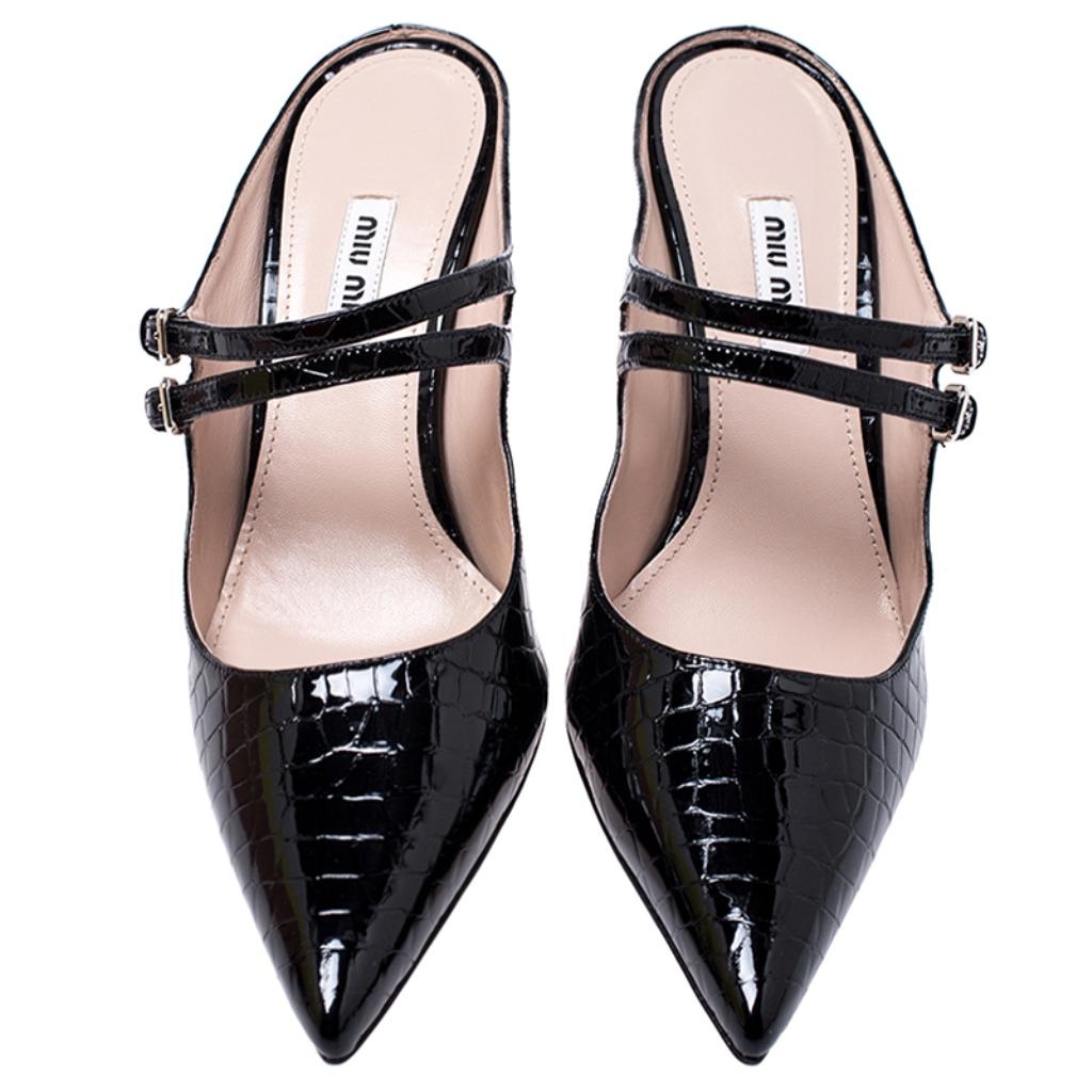 Pick this gorgeous pair of mules and flaunt your style. This pair from the house of Miu Miu is made from black patent leather and feature two buckled straps over the vamps, pointed toes and slim heels. Have a striking day out in these elegant