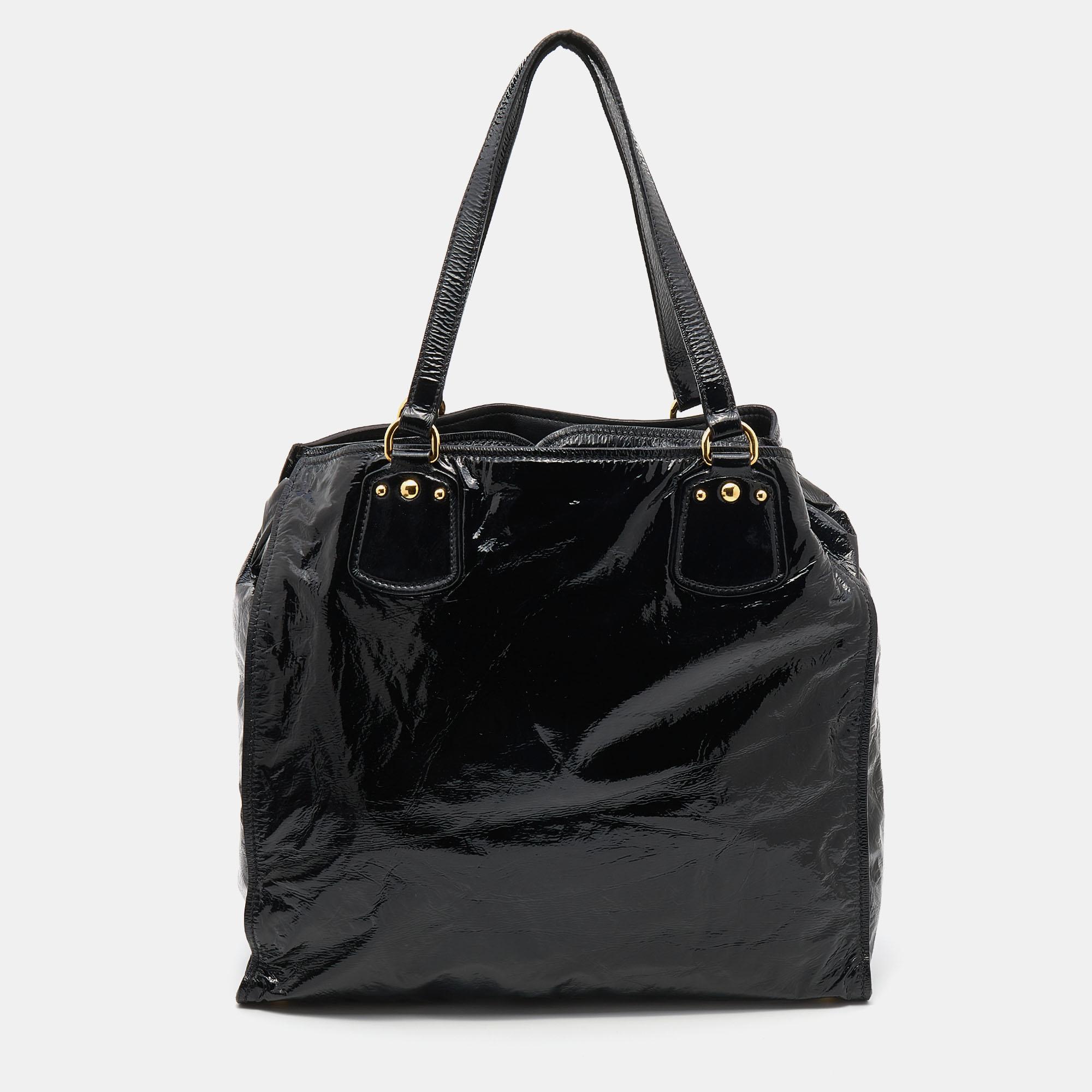 This tote by Miu Miu will remain a favorite in your wardrobe. It has been crafted using patent leather and equipped with two flat shoulder handles, gold-tone hardware, and a well-sized interior.

Includes: Original Dustbag