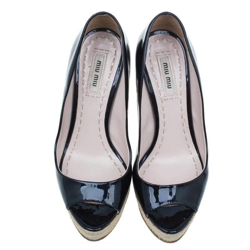 Grab these Miu Miu pumps to exhibit feminine magnetism! Crafted from black patent leather, these peep-toe platform pumps feature almond toes, bold espadrilles platforms and 13cm high chunky heels. The innersoles are leather lined and carry brand