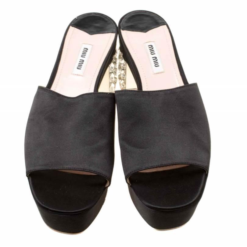 These satin sandals by Miu Miu are filled with so much beauty, they make our hearts flutter. They are designed in a slide style with crystals decorated on the block heels. They'll look fabulous with dresses and gowns.

Includes: The Luxury Closet