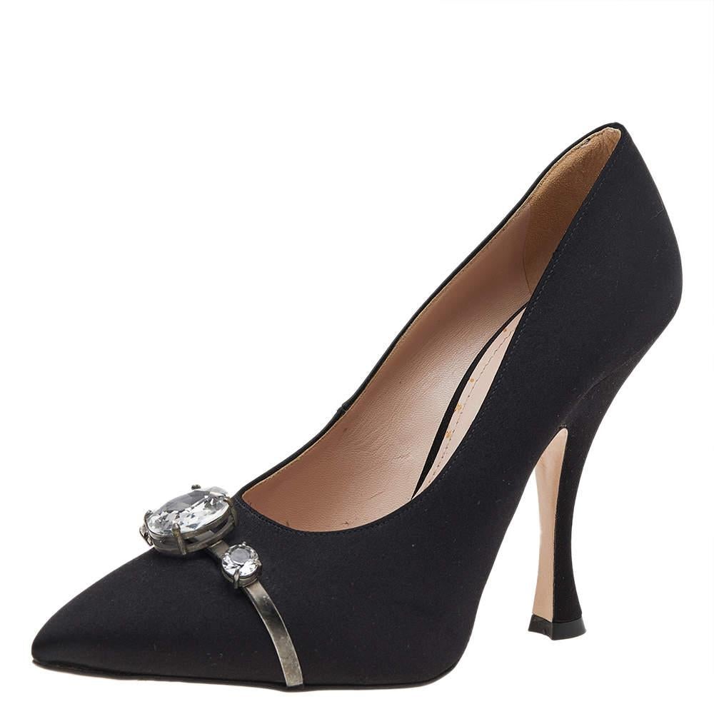 Miu Miu is well-known for graceful designs, and the label is synonymous with opulence, femininity, and elegance. These pumps are crafted from satin into a pointed toe silhouette augmented by the embellishments perched on the uppers. They are