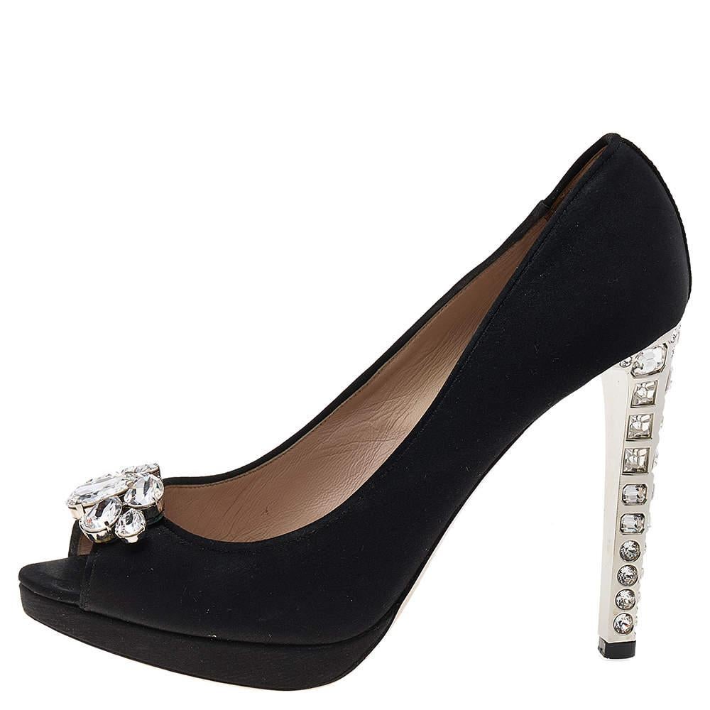 Made by Miu Miu, this pair of pumps highlight a timeless appeal. Amp up your style quotient by wearing this pair of jewel-embellished satin pumps. Let your shoes essay your sense of style when you don this pair of black pumps.