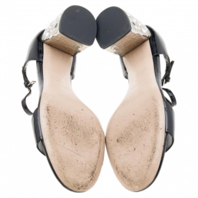 Made by Miu Miu, this pair of pumps highlight a timeless appeal. Amp up your style quotient by wearing this pair of jewel-embellished satin pumps. Let your shoes essay your sense of style when you don this pair of black pumps.