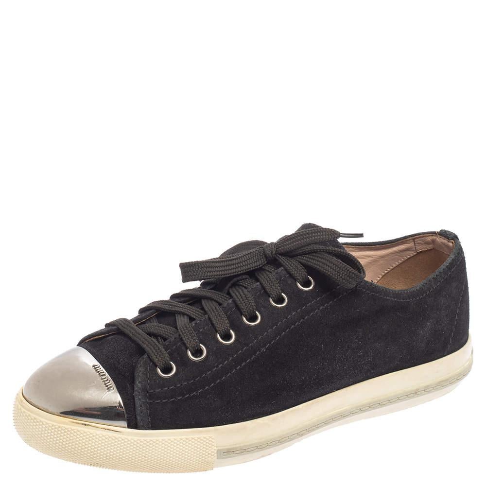These sneakers from Miu Miu are a fine choice for everyday use! The sneakers have been crafted from black suede and feature metal cap toes. They come equipped with comfortable leather-lined insoles, laced vamps, and tough rubber soles.