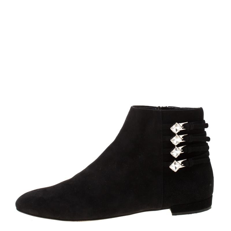 Miu Miu brings you these gorgeous black ankle boots that come flowing with comfort and fashion. They've been crafted from suede and designed with crystal-embellished buckle details, side zippers, and round toes.

Includes: Original Dustbag

