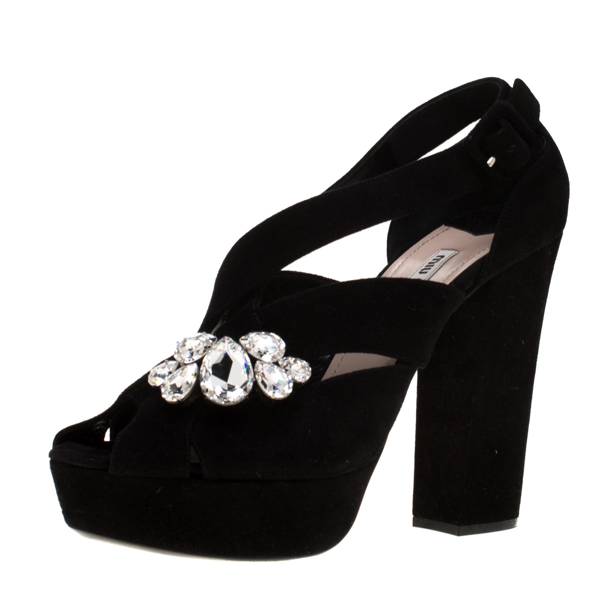 Channel your inner fashionista with these stylish sandals from the house of Miu Miu. This suede pair, with crystal embellishments and heels supported by platforms, would make all heads turn. These black beauties will accentuate your outfit on every