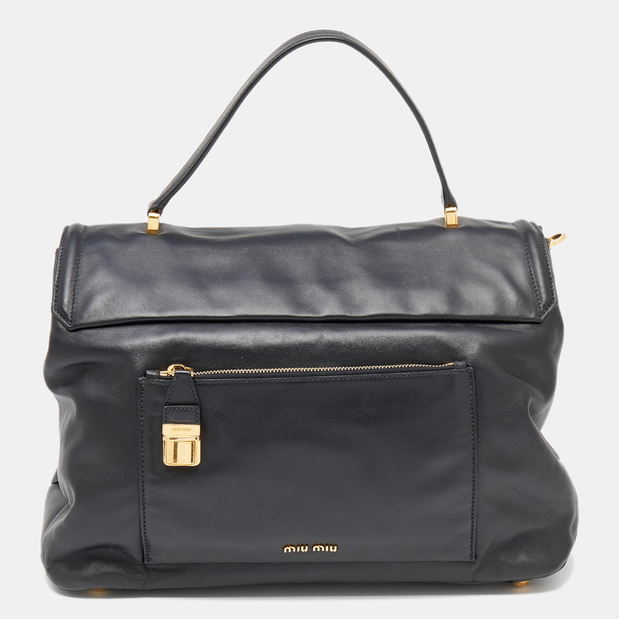 Miu Miu delivers a classy everyday bag crafted from black Vitello soft leather and gold-tone hardware. It is spaciously sized to hold the things you need for your daily commute or travel escapades. The bag suspends from a top handle and a bag
