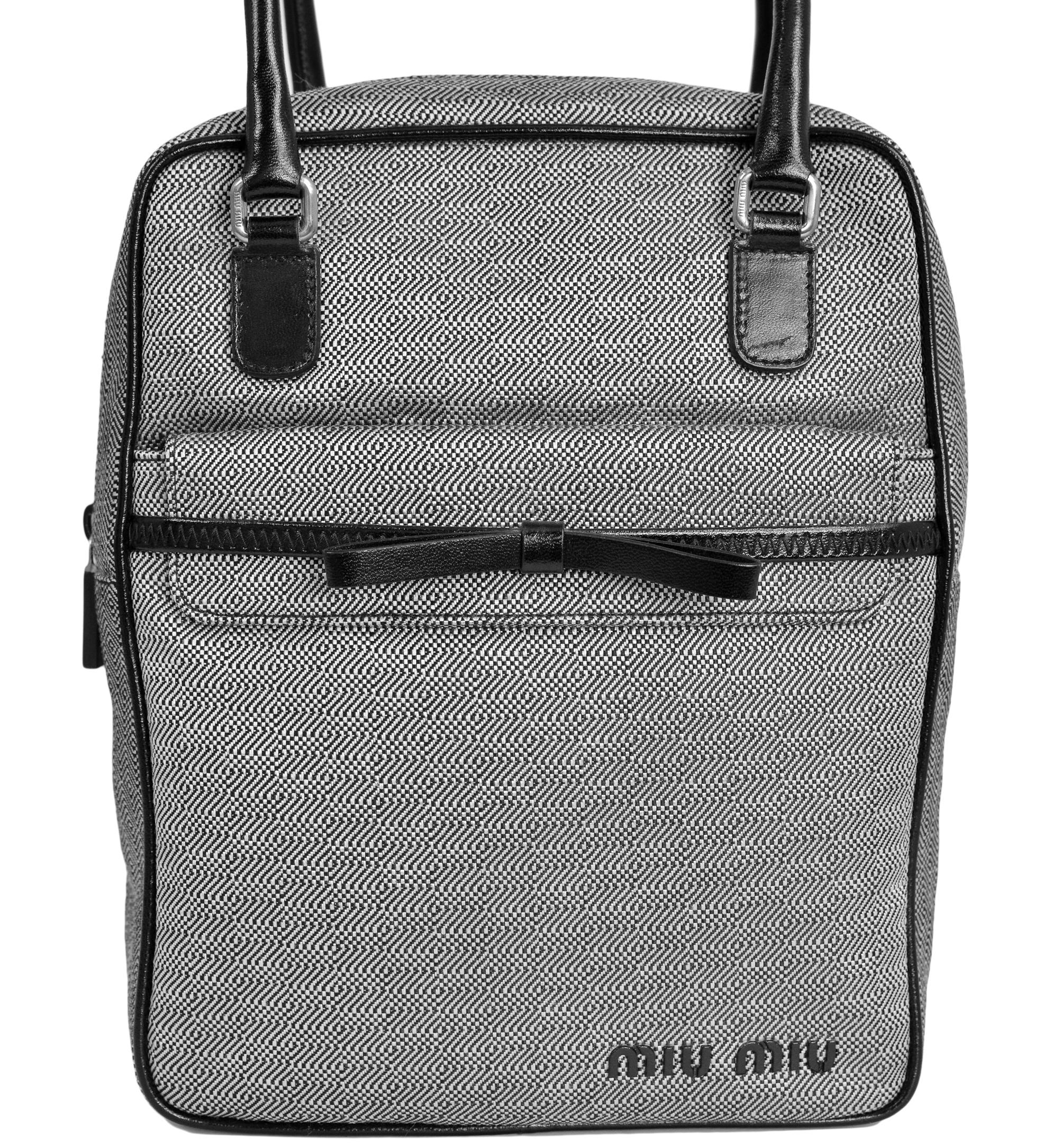 Resurrection Vintage is excited to offer a vintage Miu Miu black and white bowling bag style handbag that features a geometric print, black leather trim and bow, front pocket with flap, and chrome hardware. 

Miu Miu
Size Medium
Woven Fabric,
