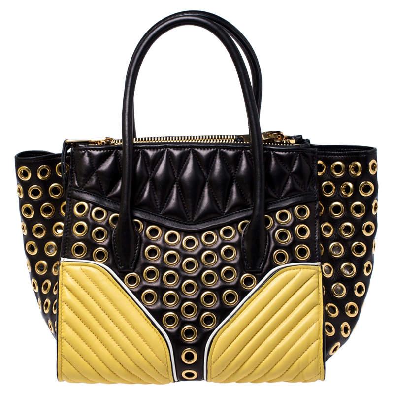 Bold design and exquisite detailing define this biker convertible tote with utter charm. It is crafted from black leather and is fabulously designed with Metalasse-detailed gold panels which carry zipper pocket to the front, gold-tone eyelets all