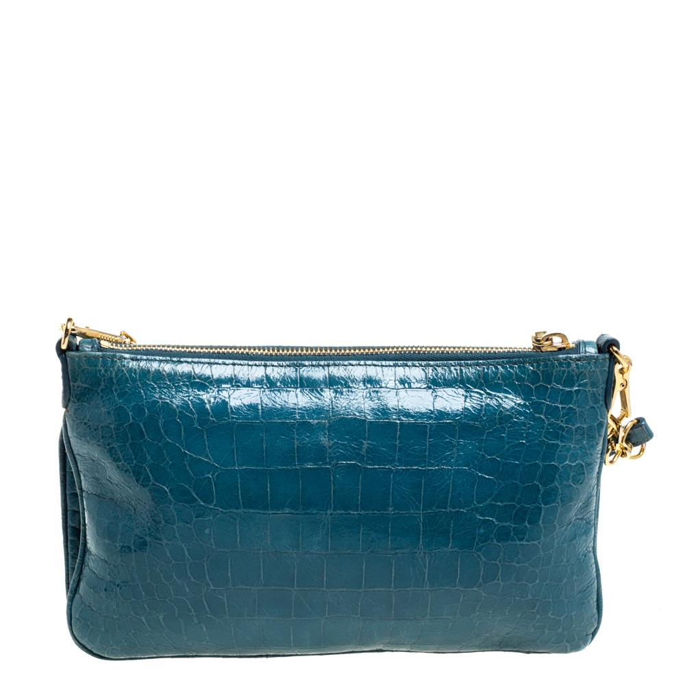 Here's a bag from Miu Miu that is both stylish and functional! Crafted from blue croc-embossed leather, the crossbody bag is divided into two sizeable fabric-lined compartments that make it easy to organize your daily essentials. It has zip